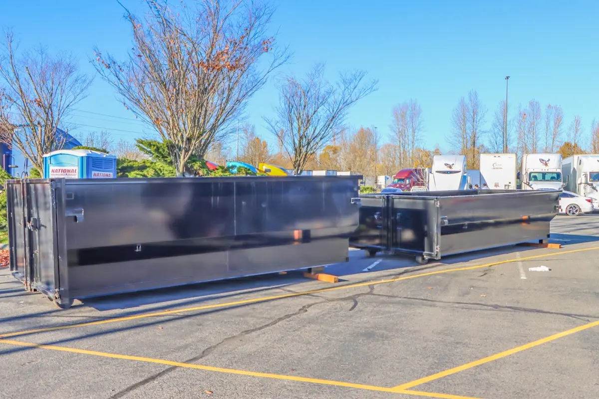 Professional dumpster rental service with roll-off container on residential driveway in Floral Park